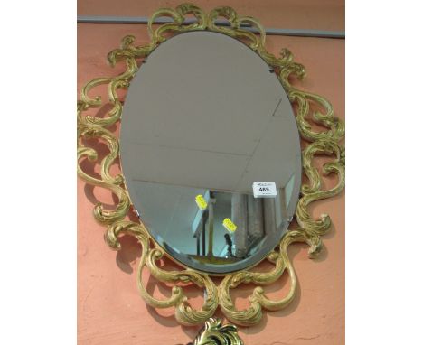 Bevel plated, oval, wall mirror with scroll frame.