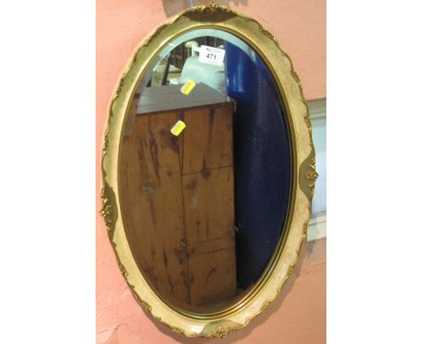 Oval, bevel plated mirror with gilt scroll frame.