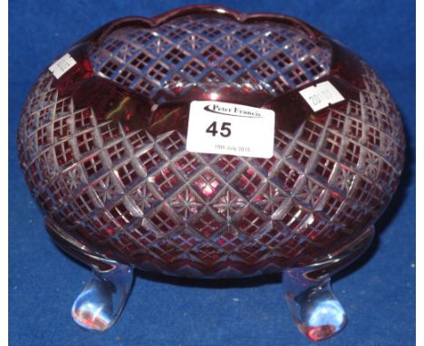 Ruby flash cut bowl raised on three legs.