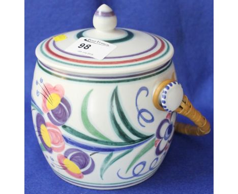 Poole pottery circular biscuit jar and cover with wicker type handle.