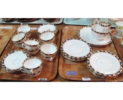 Two trays of Court china part tea ware items on a white ground with gilt and floral banding comprising tea cups, saucers, pla