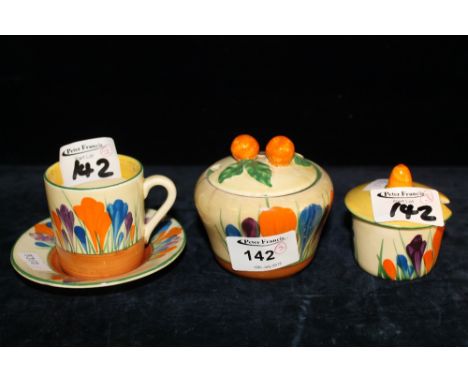 Clarice Cliff pottery items to include crocus bizarre cup and saucer, reserve pot and cover, and another jar and cover.  (3) 