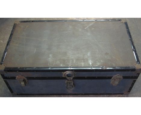 Vintage travelling trunk with brass and metal banding.