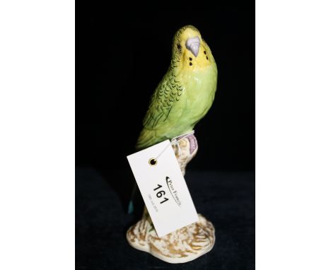 Royal Worcester bone china model of a green Budgerigar perched upon a gilt and floral naturalistic stump.  Black printed mark