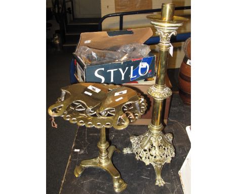 Early 20th Century brass candlestick holder raised on paw feet together with pair of trivet stands and brass miniature pierce