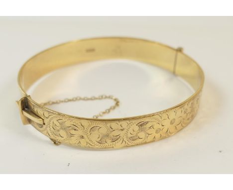 Modern 9ct gold hinged bangle, with scroll decoration, safety chain, 6cm, weight approx. 20.6g (Viewing is by appointment onl