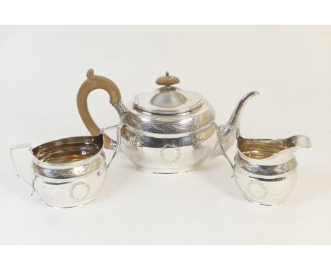 Modern silver three piece tea service, by Roberts &amp; Belk, Sheffield 1979, in Georgian style, having an oval teapot with a