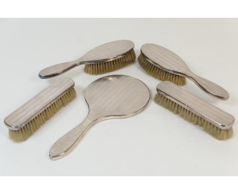 George V Britannia silver five piece dressing table set, London 1929, comprising hand mirror, two hair brushes and two clothe