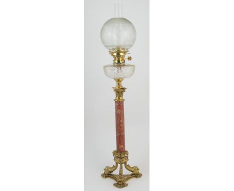 Decorative brass and cut glass oil lamp, having a globular etched glass shade, complete with chimney, over a clear glass tank