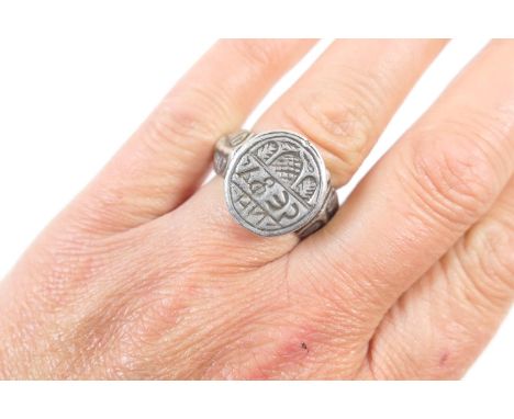 Unusual silver seal ring, possibly Greek, the seal incised with possibly a door and script, with feathered bezel, supported o