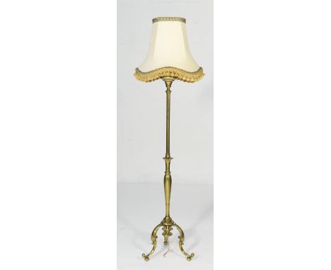 Brass extending standard lamp, having a tank, now converted to electricity, over an extendable column and three cabriole supp