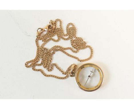 9ct gold compass pendant, suspended from a 9ct gold fine curb link necklace, the compass 15mm diameter, the necklace 44cm, gr