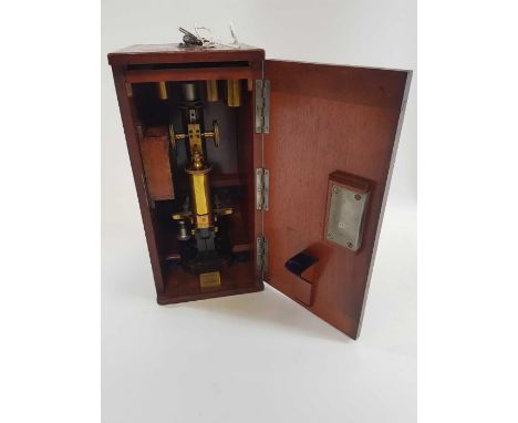 A brass monocular microscope by C. Reichert no.19301 in fitted case with one objective in brass case, other empty cases, an o