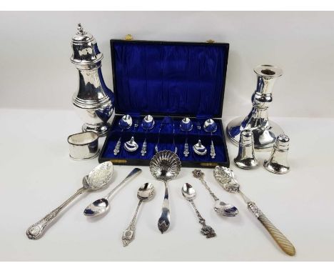 A silver sugar sifter, a weighted silver candlestick, a silver salt and pepper, various other silver items and silver plated 