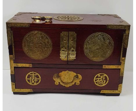 A Chinese hardwood jewellery box with brass fittings, bindings and decoration, 30.5cm wide, 20cm high, 16.3cm deep; and a vin