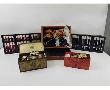 Two sets of vintage dominoes, a set of wooden chess pieces and two wooden abacuses
