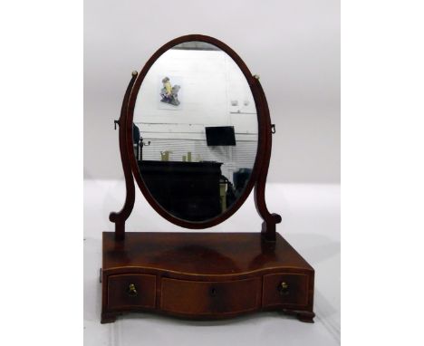 19th century mahogany oval toilet mirror, the serpentine-shaped box base fitted three drawers and on bracket feet&nbsp;