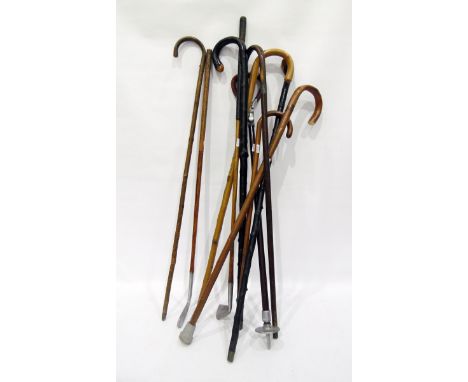 Quantity of walking sticks, vintage golf clubs and shooting stick (10)   
