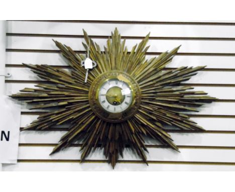 French giltwood sun-burst wall clock, having circular white painted dial and rococo gilt metal pieced hands, 68 cms wide appr