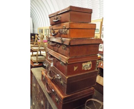 A group of vintage leather suitcases 