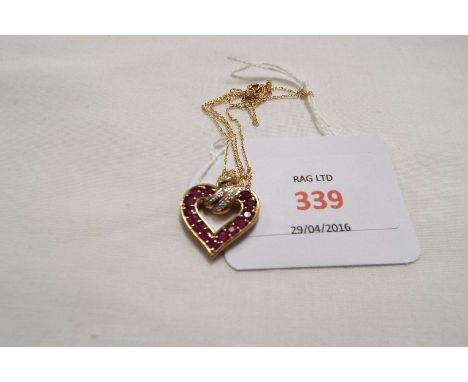 A 9ct gold fine rope twist chain with ruby and clear stone set heart pendant