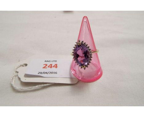 A 9ct gold ring inset with marquise cut amethyst flanked by diamonds, size  Q