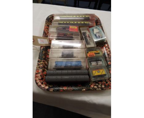 A selection of boxed Hornby Minitrix carriages and trucks, nos. 301, 302, 509, 2x 510, 511 and 514, five boxed Peco N gauge t
