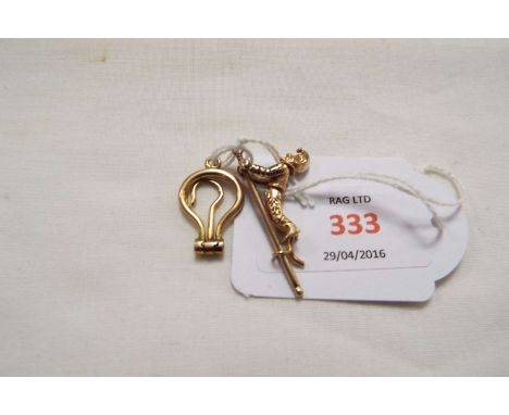 Two unmarked gold charms; a folding miniature button hook and an articulated climbing jester