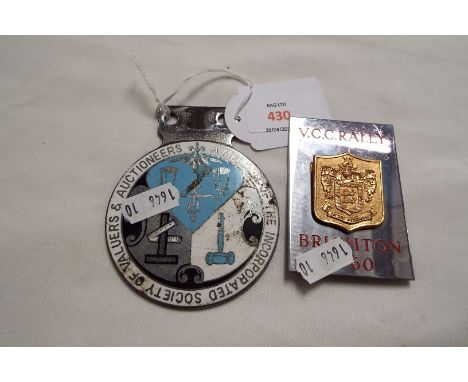 A vintage enamel and chrome 'Society of Valuers and Auctioneers' car badge, together with a V.C.C. Brighton Rally 1960 car ba