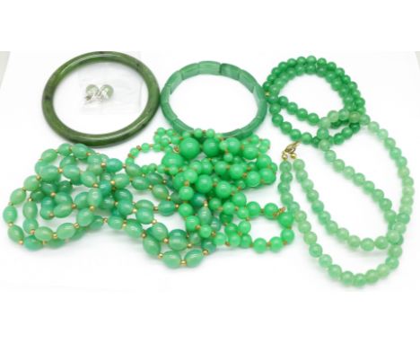 A bangle, bracelet and four bead necklaces