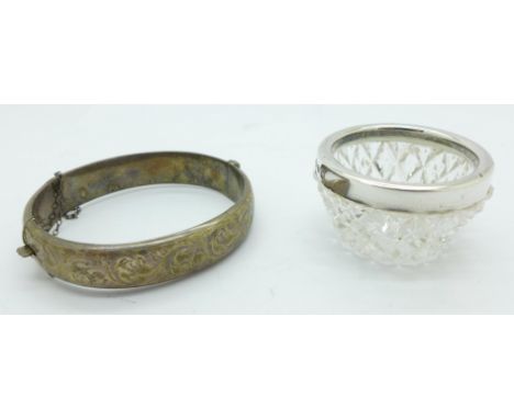A silver rimmed salt and a silver bangle