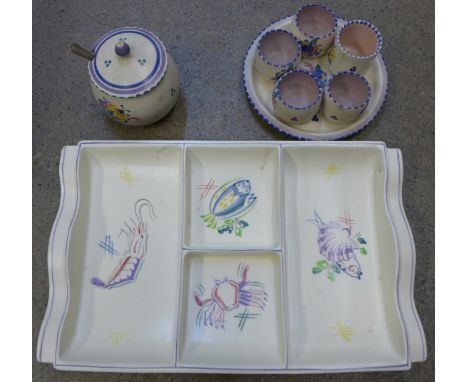 Four pieces of Poole; egg cups, preserve pot and nut dish