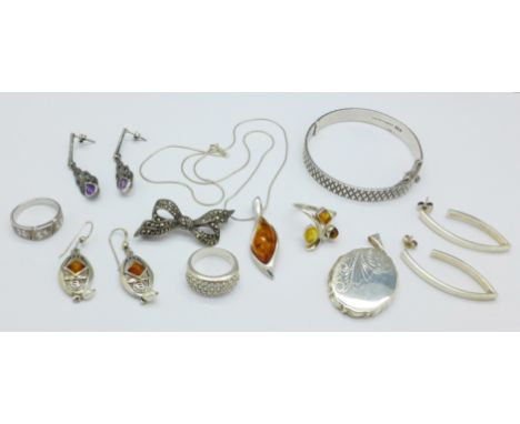 A collection of silver jewellery including a hallmarked locket and bangle