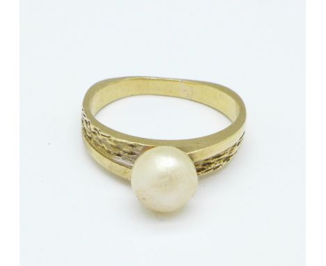 A yellow metal and pearl ring, tests as 9ct, 3.8g, N