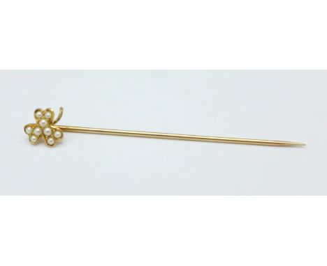 A yellow metal and pearl stick pin, tests as 9ct gold