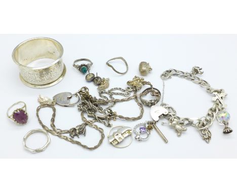 Silver jewellery including a charm bracelet and a silver napkin ring