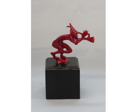 Red Devil Light Car Mascot. A small cock-a-snook mascot, with a red enamel finish, firmly display mounted, Total height 13 cm