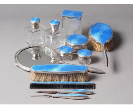 A silver and blue guilloche enamel dressing table set, comprising a mirror, two brushes, a pair of matching scent bottles wit