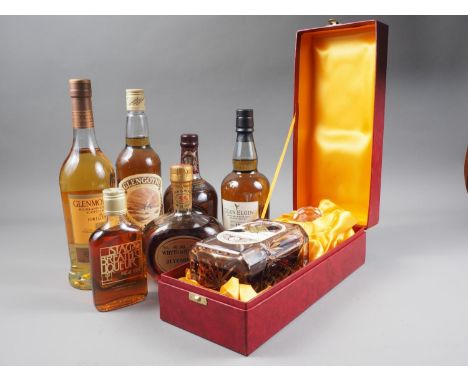 A bottle of 10 year old Glenmorangie single malt Scotch whisky, in box, a wax sealed Edinburgh Crystal decanter containing Gl