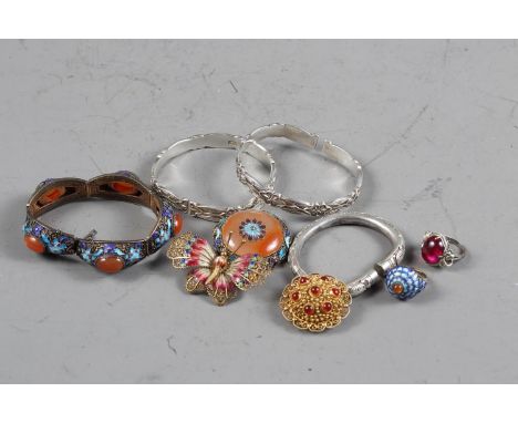 A Chinese gilt metal, enamel and hardstone bracelet, a similar brooch, an enamel butterfly brooch, a hardstone brooch, three 