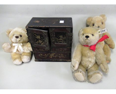 Small Steiff teddy bear, two other teddy bears and a small Japanese table cabinet 