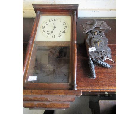 Small 20th Century Black Forest cuckoo clock, with carved decoration and two train weight driven movement, together with an o