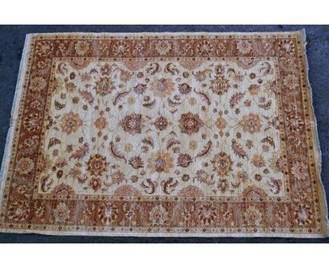 Afghan carpet of Ziegler design with an all-over palmette pattern on an ivory ground with borders, 286cms x 206cms 