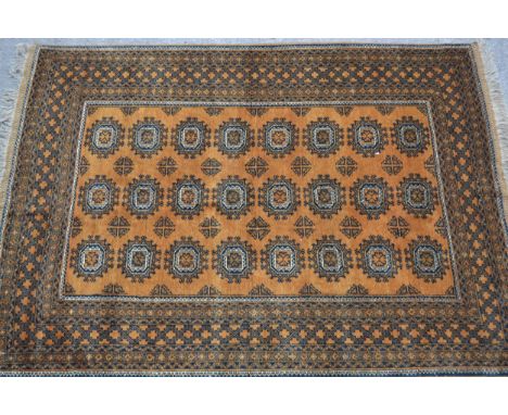 Afghan gold ground carpet with three rows of eight gols within a multiple border, 290cms x 210cms 