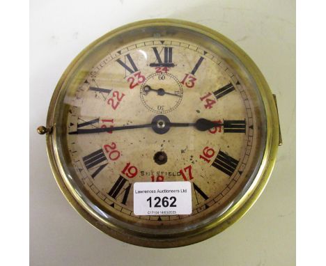 Circular brass ship's bulkhead clock, the enamel dial with Roman and Arabic twenty four hour numerals and subsidiary seconds,