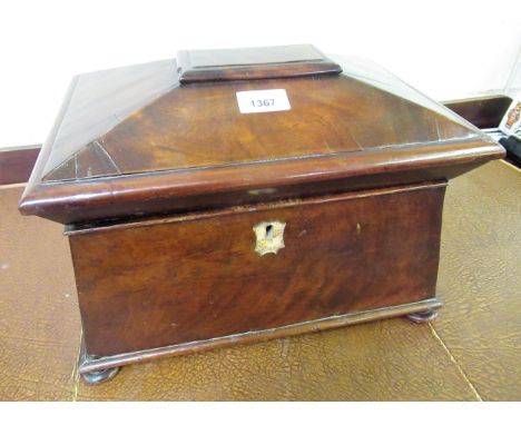 19th Century mahogany sarcophagus shaped tea caddy, the hinged covering enclosing a three division interior on low bun suppor