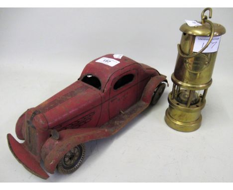 Tin plate clockwork Mystery car (at fault) and a miniature brass miners lamp by Hockley Lamp & Limelight Company 