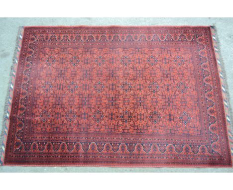 Modern Afghan Belouch carpet with three rows of six gols on wine ground with borders, 300cms x 208cms approximatelyNeeds a go