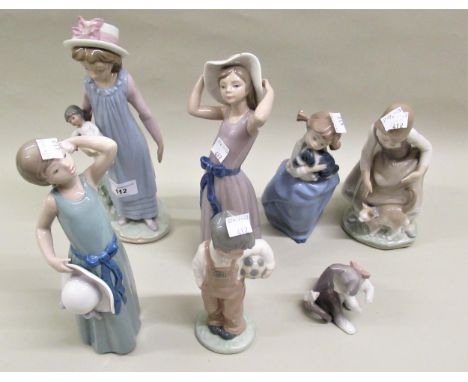 Group of five Lladro figures of young girls and a cat (one at fault), and two smaller Nao figures of a young boy and girl 