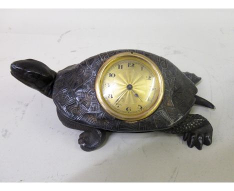 Novelty table clock, mounted with a spelter figure of a tortoise, the gilt dial with Arabic numerals 